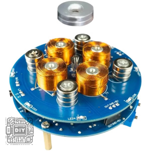 Blue circular circuit board populated with several orange copper coils and silver inductors; a detached metal spacer sits above the assembly